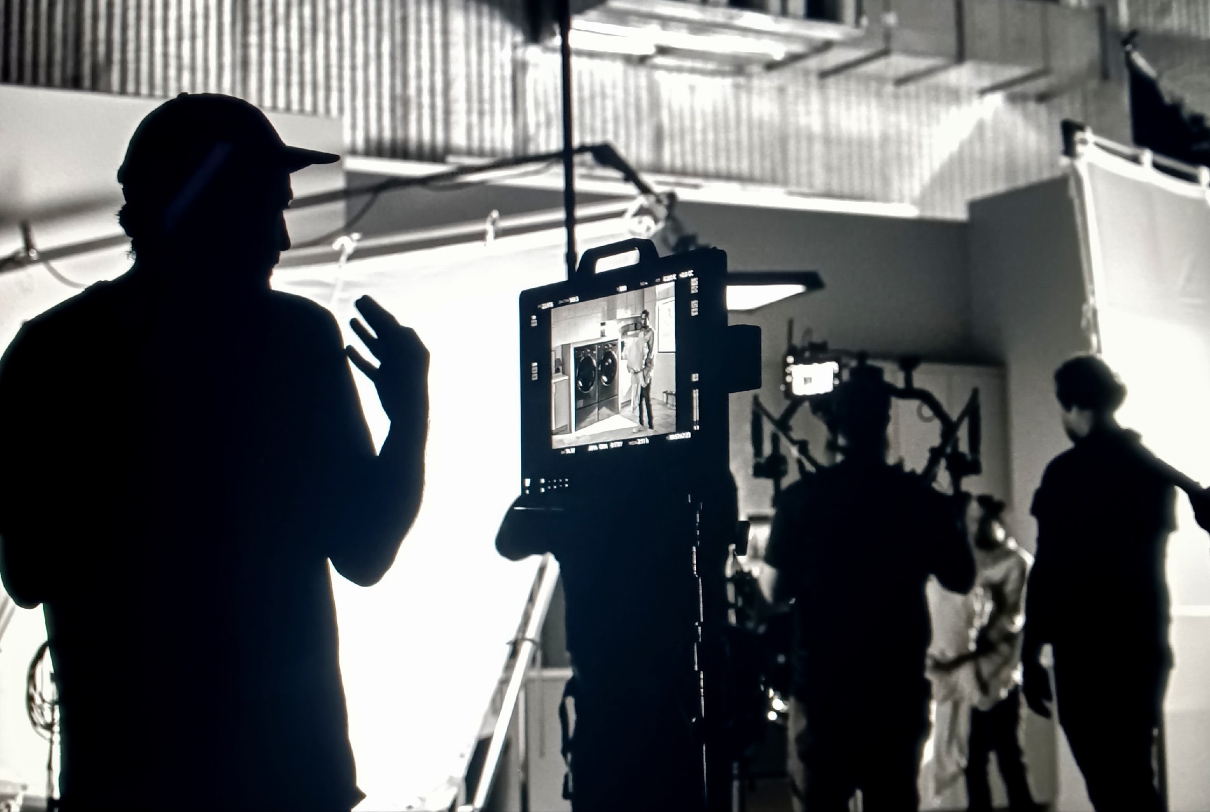 Roberto Chamorro directing on set, monitor showing the shot